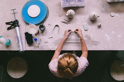 A student working on pottery. Link to Gifts That Pay You Income A student working on pottery. Link to Gifts That Pay You Income
