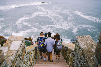 Students walking down stairs towards a body of water. Link to Gifts from Retirement Plans